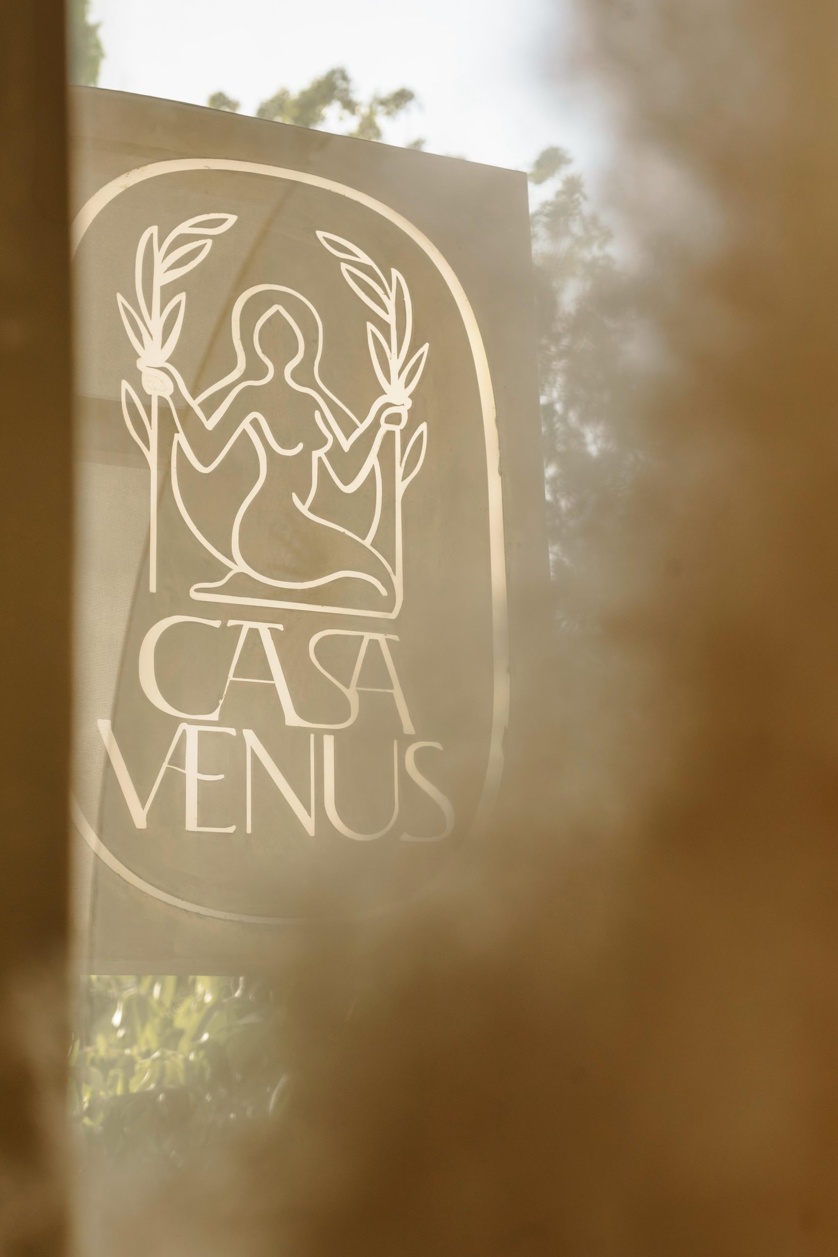 Casa Venus logo on glass